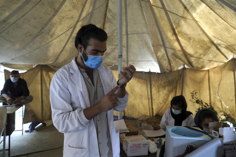 A doctor fills a syringe with the Johnson & Johnson COVID-19 vaccine donated through the U.N.-backed COVAX program at a vaccination center in Kabul, Afghanistan, Sunday, July 11, 2021.