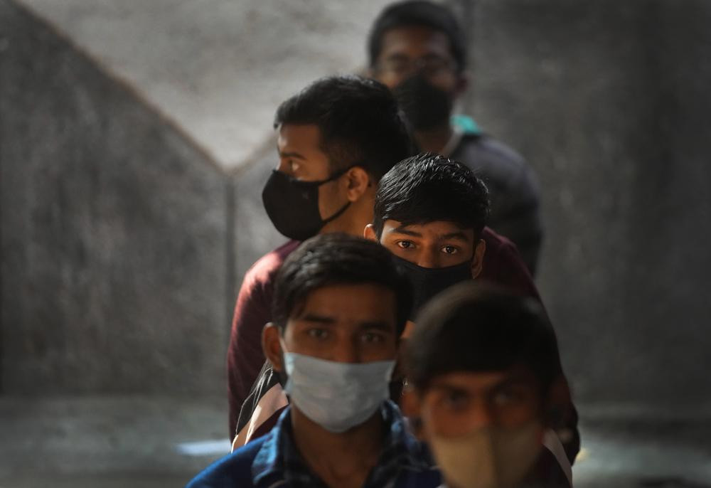 Children wait to receive their vaccination for COVID-19 at a government school in New Delhi, India, Monday, Jan. 3, 2022. Indian health authorities Monday began vaccinating teens in the age group of 15 to 18.
