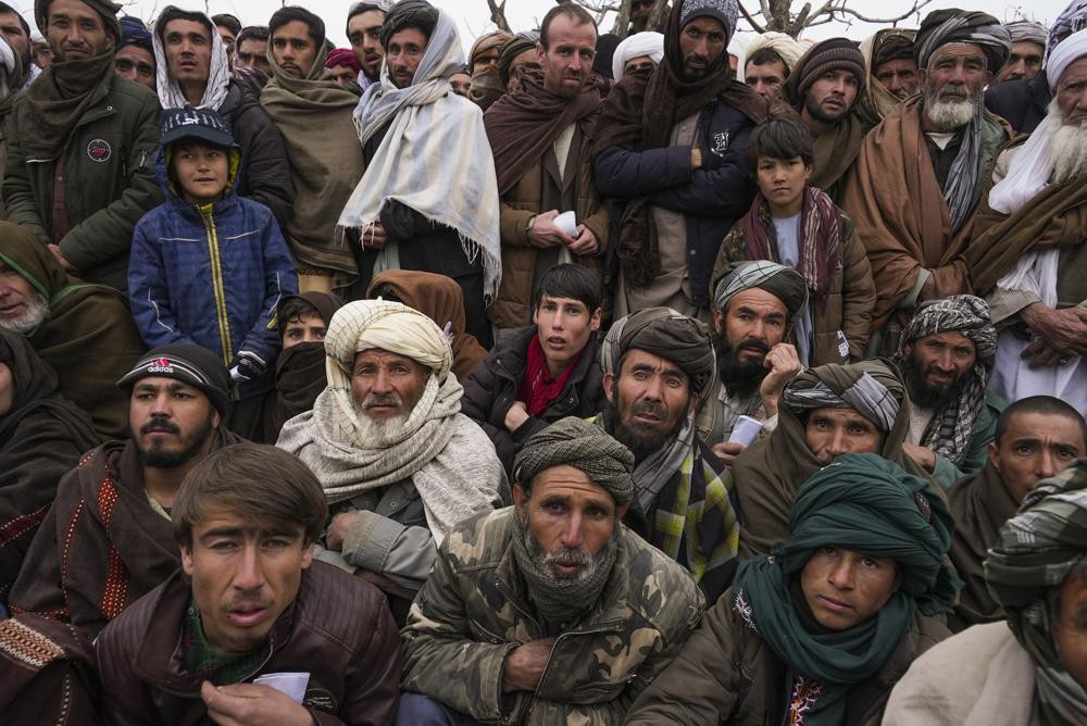 Hundreds of Afghan men gather to apply for the humanitarian aid in Qala-e-Naw, Afghanistan, Tuesday, Dec. 14, 2021.