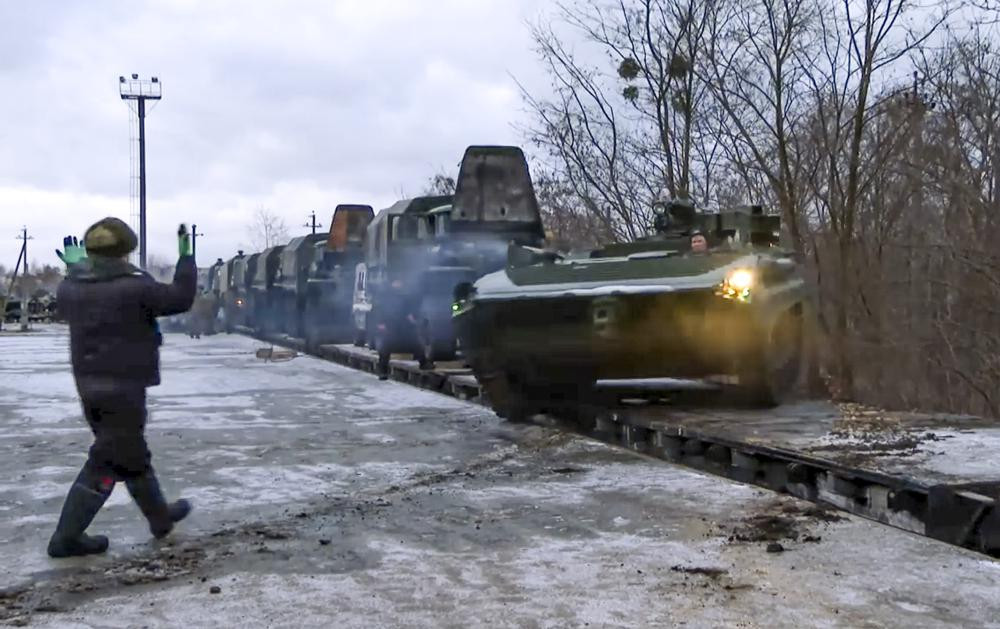 In this photo taken from video provided by the Russian Defense Ministry Press Service, A Russian armored vehicle drives off a railway platform after arrival in Belarus, Wednesday, Jan. 19, 2022.
