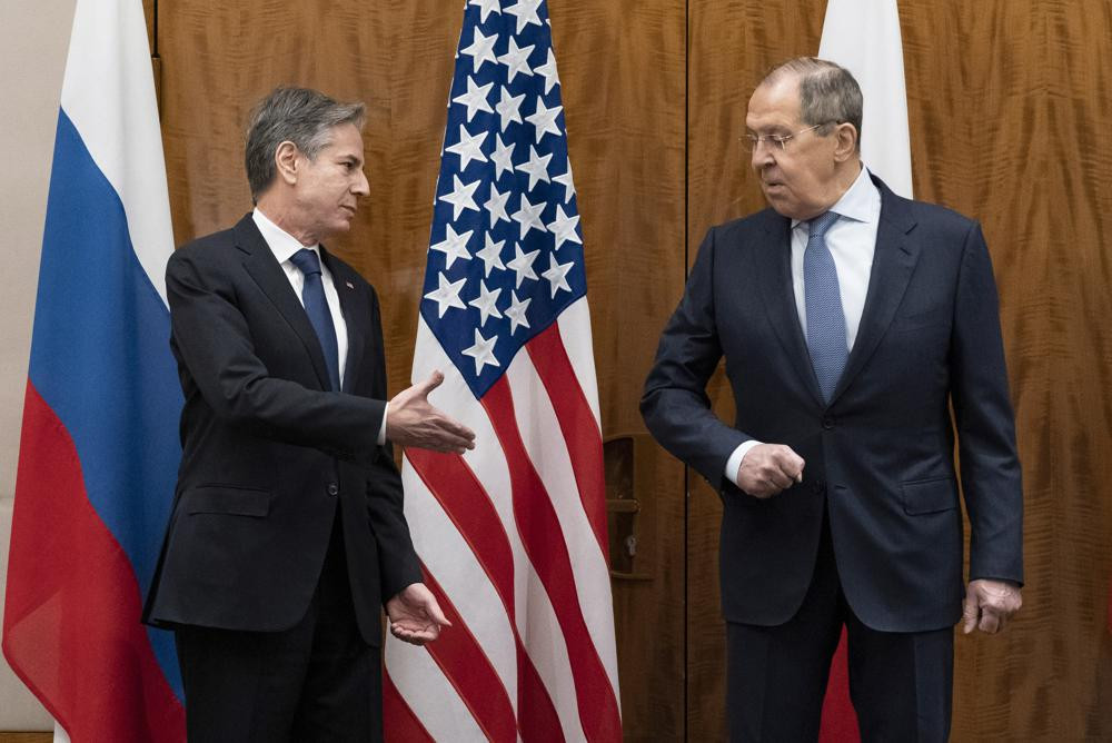 US Secretary of State Antony Blinken, left, greets Russian Foreign Minister Sergey Lavrov before their meeting, in Geneva, Switzerland, Friday, Jan. 21, 2022.