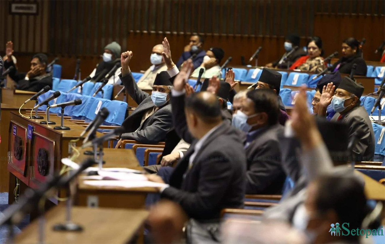 Lawmakers raise their hands for ratification of the MCC Compact during the voice vote Sunday. Photo: Nisha Bhandari