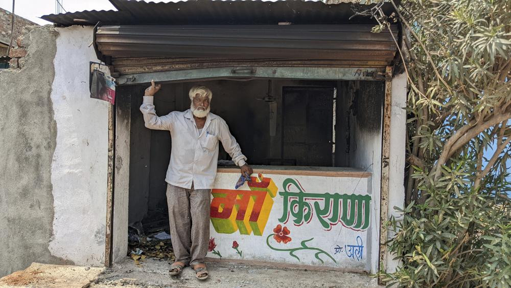 Nawab Khan stands by the entrance of his shop vandalized by a mob on April 10 in Khargone, in the central Indian state of Madhya Pradesh, Tuesday, April 12, 2022.
