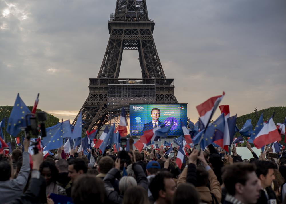 French President Emmanuel Macron celebrates with supporters in front of the Eiffel Tower Paris, France, Sunday, April 24, 2022.