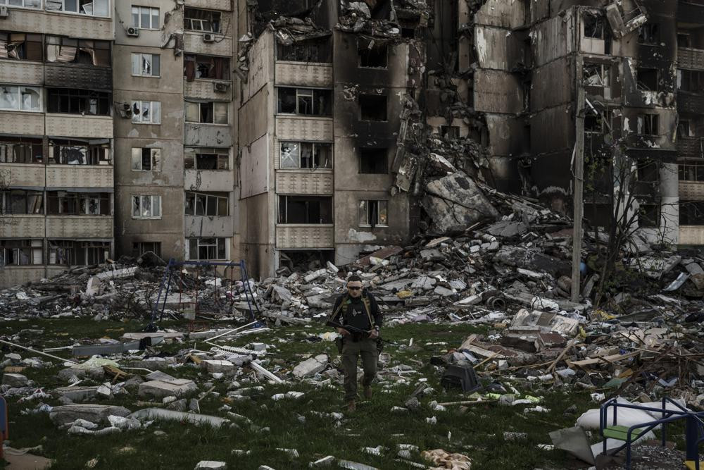 A Ukrainian serviceman walks amid the rubble of a building heavily damaged by multiple Russian bombardments near a frontline in Kharkiv, Ukraine, Monday, April 25, 2022.