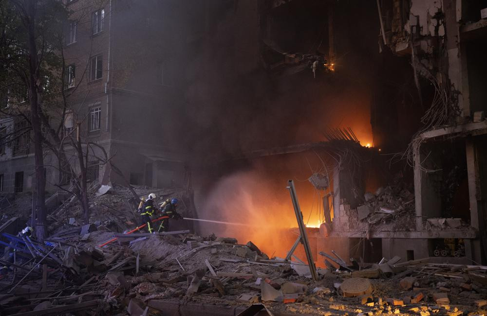 Firefighters try to put out a fire following an explosion in Kyiv, Ukraine on Thursday, April 28, 2022. Russia mounted attacks across a wide area of Ukraine on Thursday, bombarding Kyiv during a visit by the head of the United Nations.