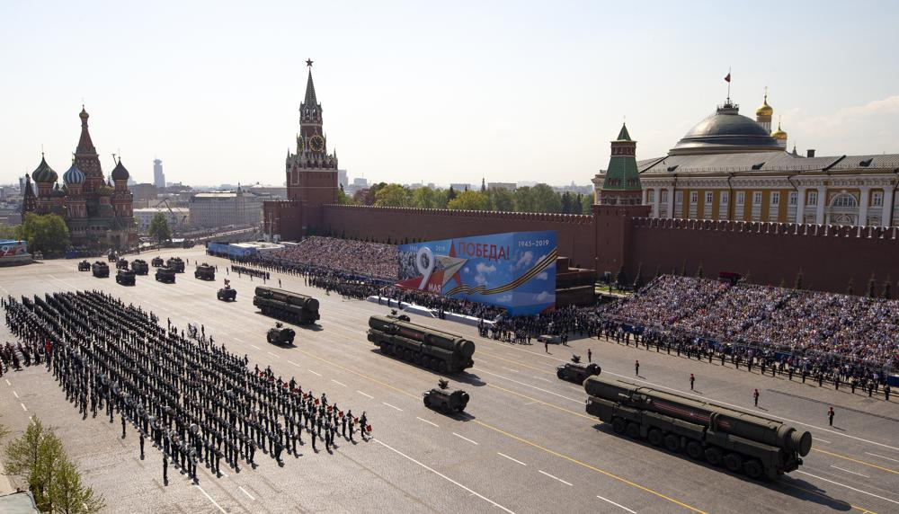 FILE - Russian military vehicles roll down Red Square Red Square during a rehearsal for the Victory Day military parade in Moscow, Russia, on May 7, 2019.