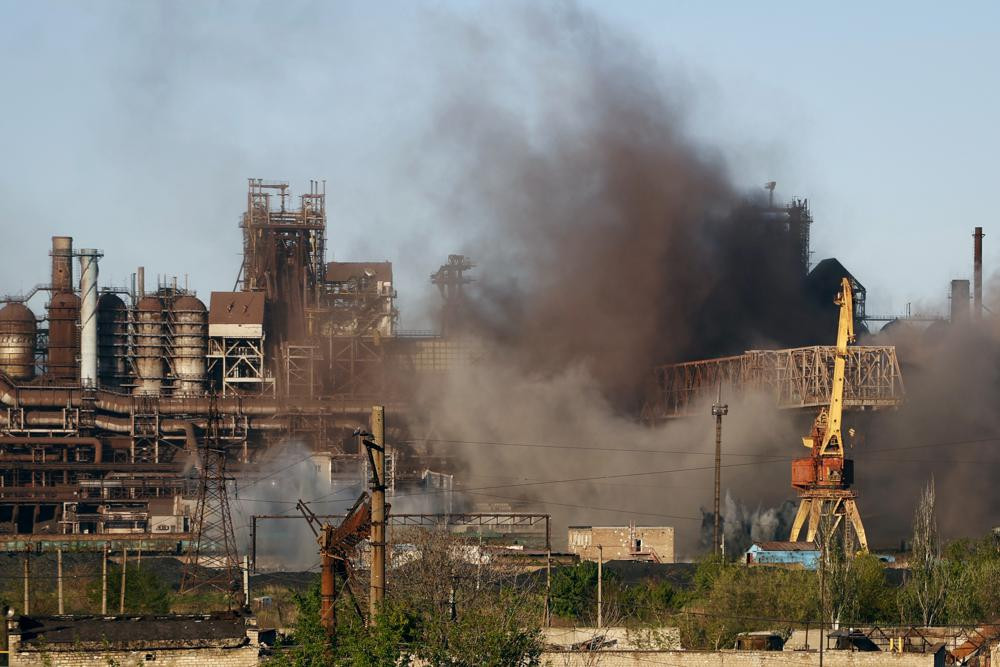 Smoke rises from the Metallurgical Combine Azovstal in Mariupol during shelling, in Mariupol, in territory under the government of the Donetsk People's Republic, eastern Ukraine, Saturday, May 7, 2022.