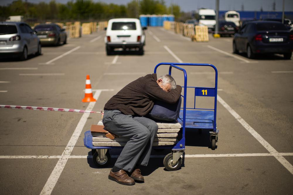 A man who fled from a small village near Polohy rests upon his arrival to a reception center for displaced people in Zaporizhzhia, Ukraine, Sunday, May 8, 2022.