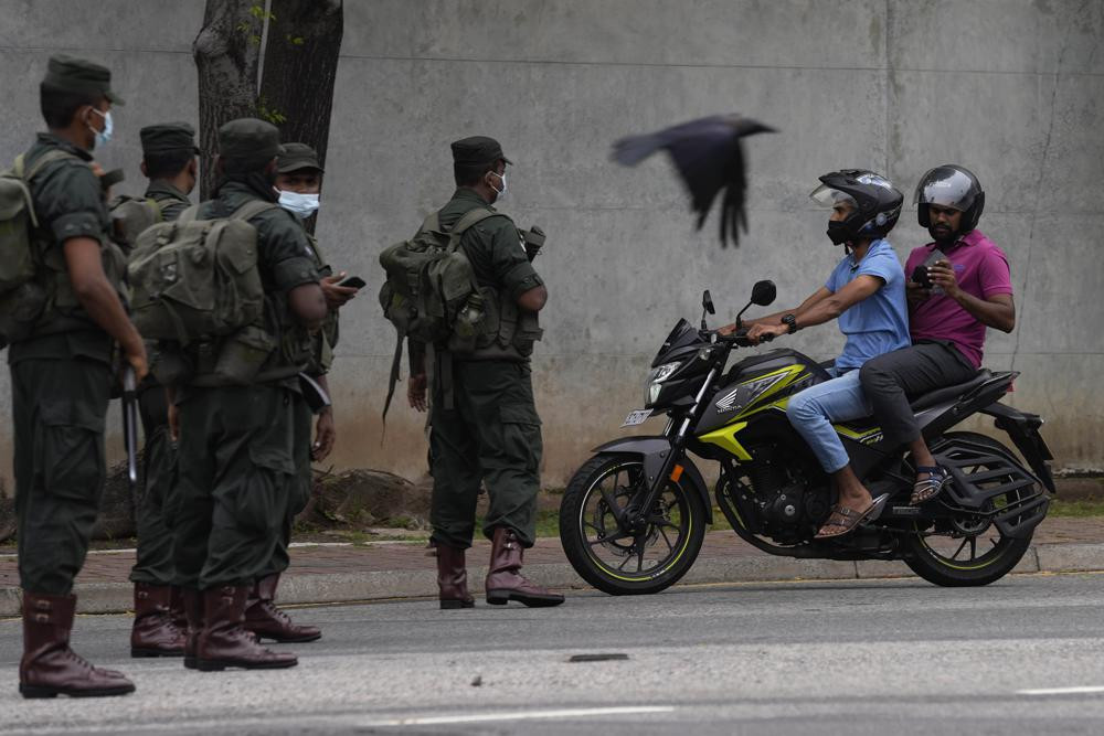 Sri Lankan army soldiers man a checkpoint during curfew imposed a day after clashes between government supporters and anti government protesters in Colombo, Sri Lanka, Tuesday, May 10, 2022.