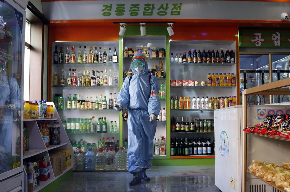 An employee of the Kyonghung Foodstuff General Store disinfects the showroom in Pyongyang, North Korea, Wednesday, Nov. 10, 2021.