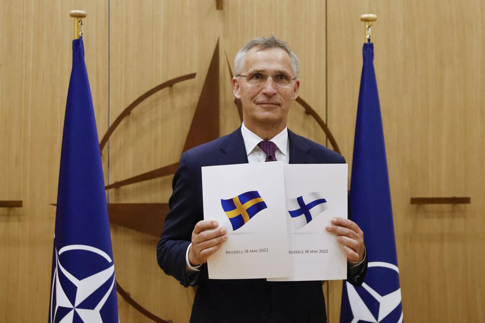 NATO Secretary-General Jens Stoltenberg displays documents as Sweden and Finland applied for membership in Brussels, Belgium, Wednesday May 18, 2022.