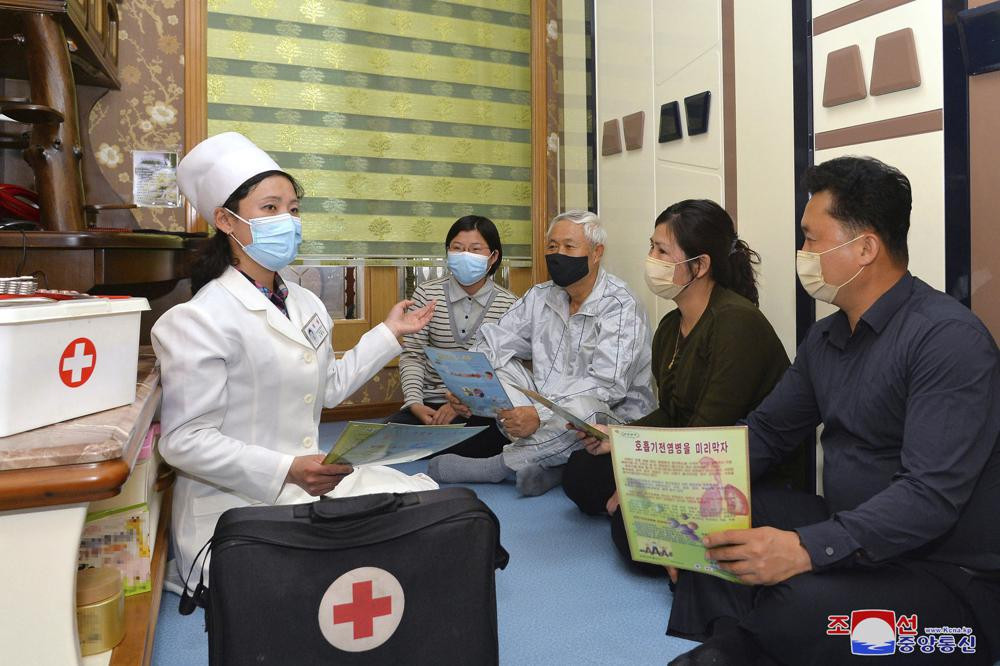 In this photo provided by the North Korean government, a doctor visits a family during an activity to raise public awareness of the COVID-19 prevention measures, in Pyongyang, North Korea Tuesday, May 17, 2022.
