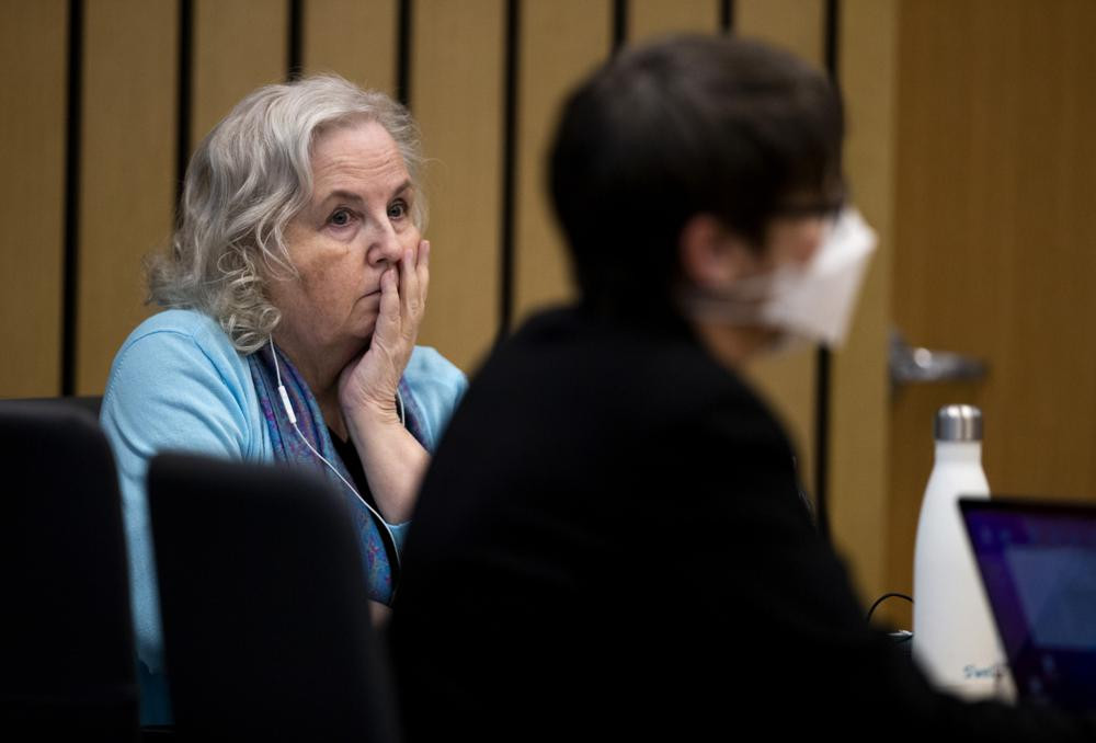 FILE - Romance writer Nancy Crampton Brophy, left, accused of killing her husband, Dan Brophy, in June 2018, watches proceedings in court in Portland, Ore., Monday, April 4, 2022.