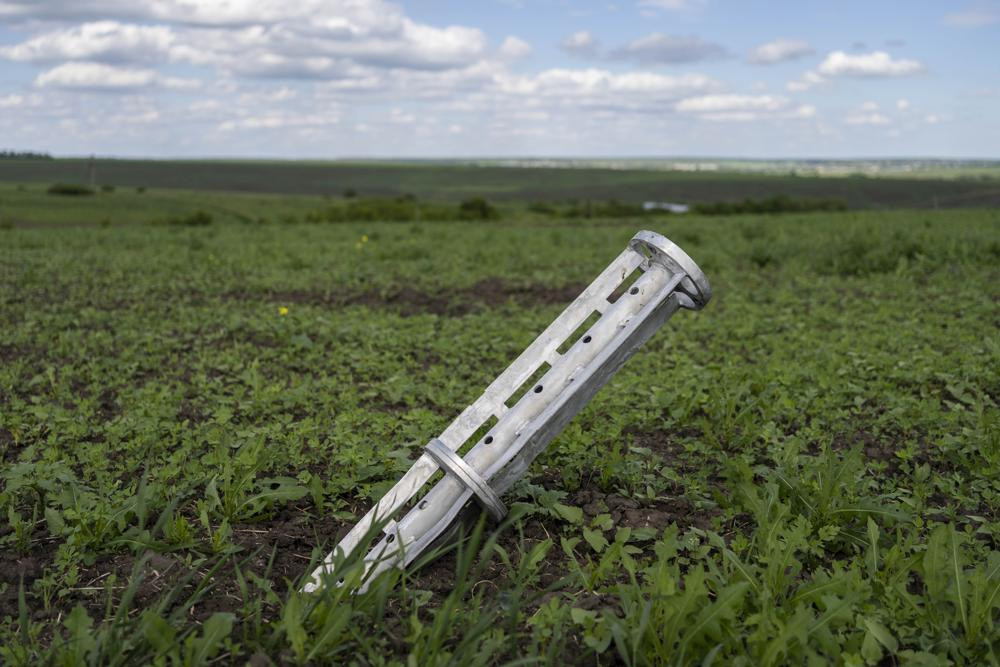 The remains of a cluster-type munition lie in a field in Cherkaska Lozova, outskirts of Kharkiv, eastern Ukraine, Saturday.