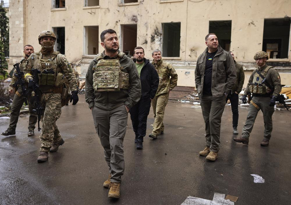 In this photo provided by the Ukrainian Presidential Press Office on Sunday, May 29, 2022, Ukrainian President Volodymyr Zelenskyy walks with his stuff as he visits the war-hit Kharkiv region.