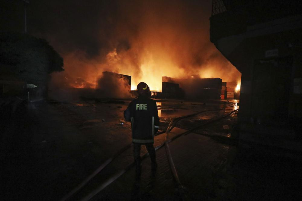 A firefighter works to contain a fire that broke out at the BM Inland Container Depot, a Dutch-Bangladesh joint venture, in Chittagong, 216 km southeast of capital, Dhaka, Bangladesh, early Sunday, June 5. (AP Photo)