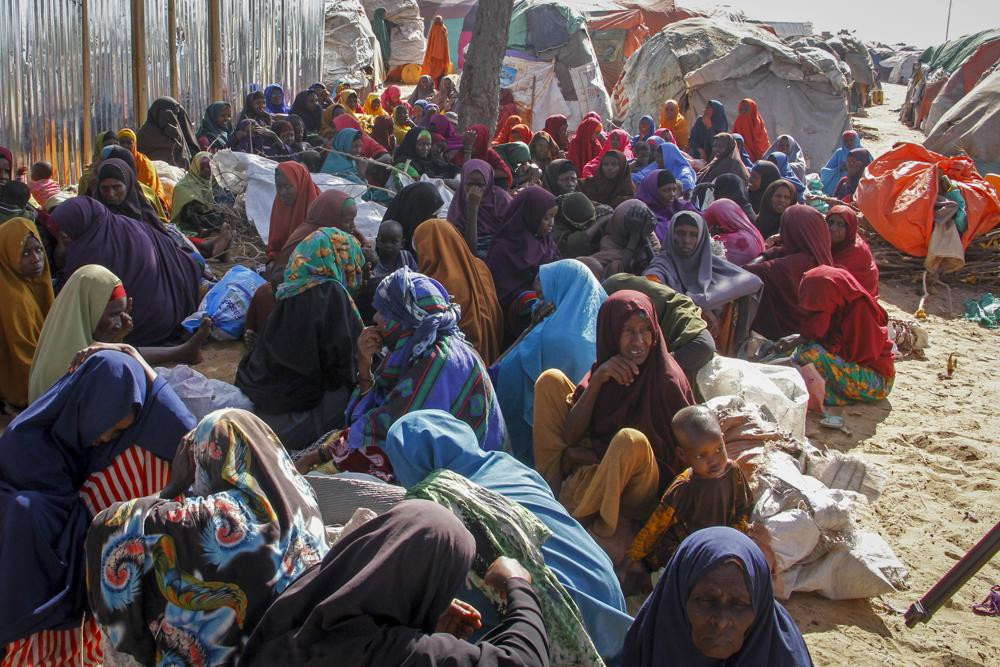 FILE - Somalis who fled drought-stricken areas sit at a makeshift camp on the outskirts of the capital Mogadishu, Somalia on Feb. 4, 2022.
