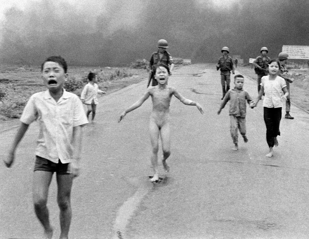 FILE - South Vietnamese forces follow terrified children, including 9-year-old Kim Phuc, center, as they run down Route 1 near Trang Bang after an aerial napalm attack on suspected Viet Cong hiding places on June 8, 1972. (AP Photo/Nick Ut, File)