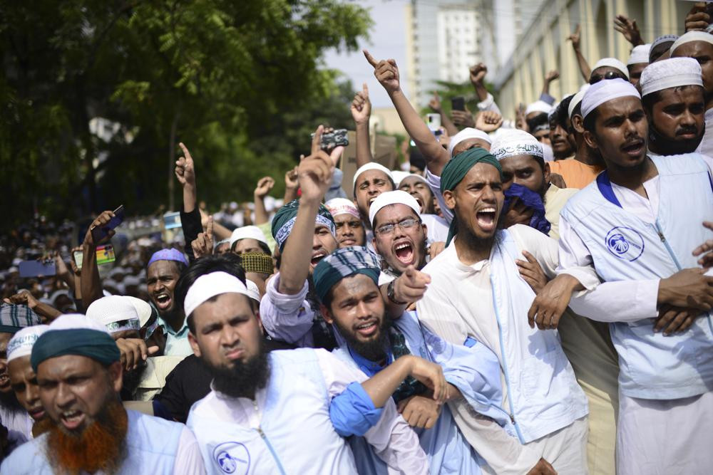 Muslims shout slogans against Nupur Sharma, a spokesperson of India's ruling BJP as they react to the derogatory references to Islam and the Prophet Muhammad made by her, during a protest outside a mosque in Dhaka on Friday.
