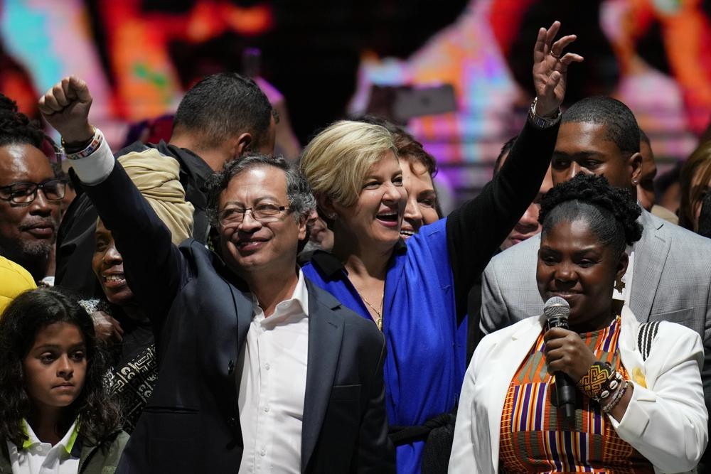Former rebel Gustavo Petro, left, his wife Veronica Alcocer, back center, and his running mate Francia Marquez, celebrate before supporters after winning a runoff presidential election in Bogota, Colombia, Sunday, June 19, 2022. AP/RSS Photo