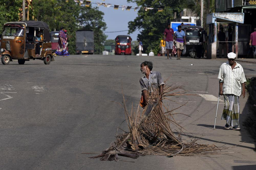 A man pulls fallen coconut leaves to be used as firewood amid shortage of cooking gas along a usually congested road in Colombo, Sri Lanka, Thursday, June 23, 2022. AP/RSS Photo
