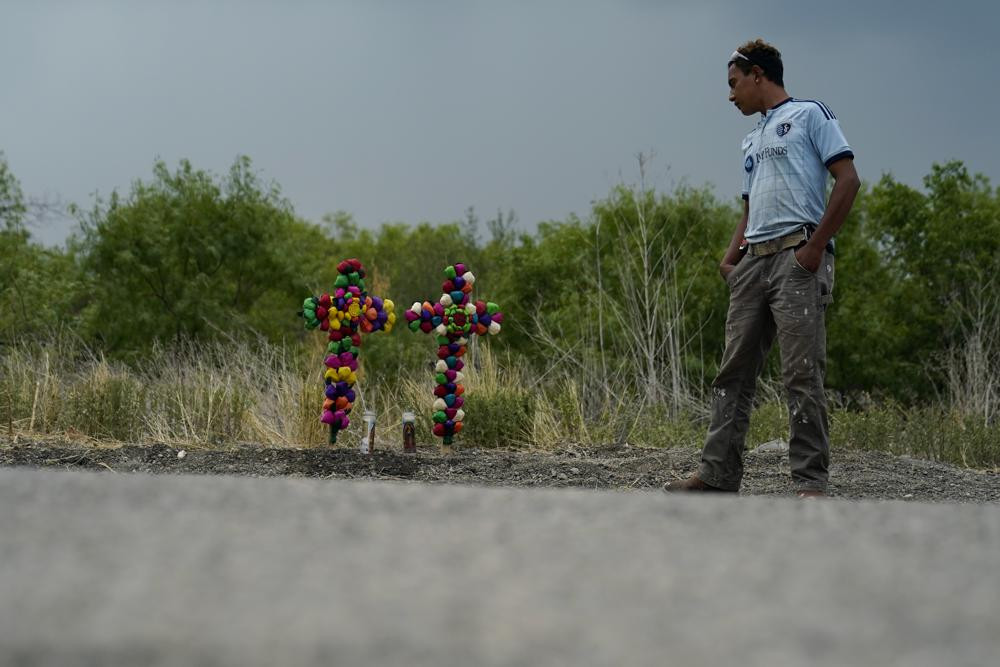 A man pays his respects at the site where officials found dozens of people dead in a semitrailer containing suspected migrants, Tuesday, June 28, 2022, in San Antonio. AP/RSS Photo