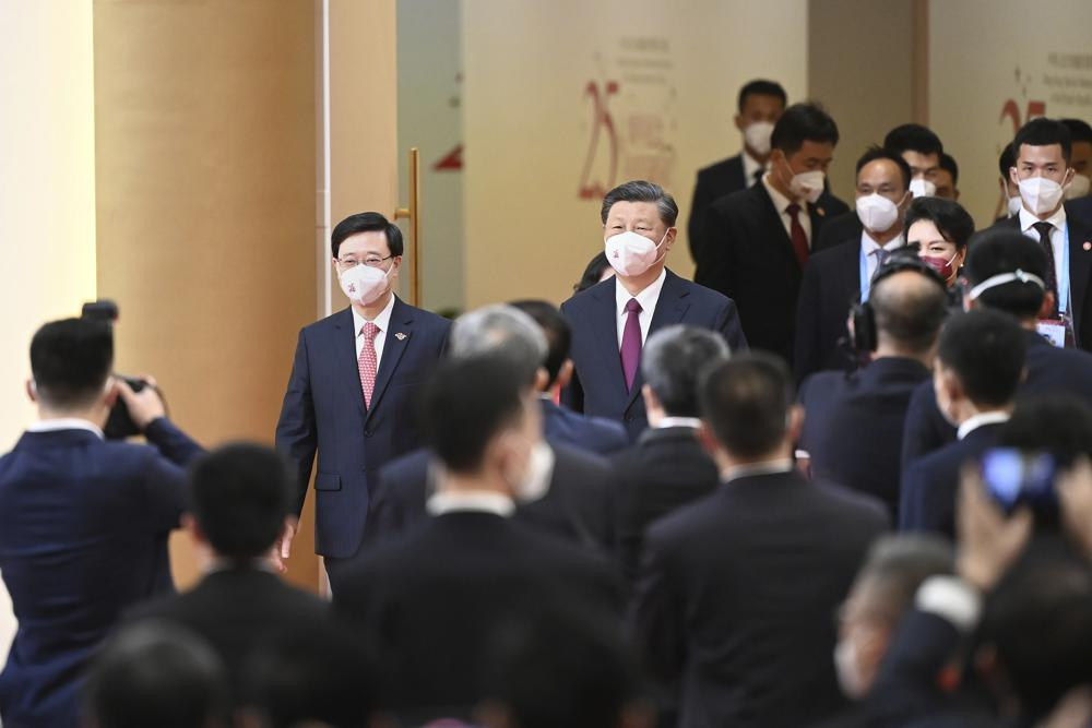 China's President Xi Jinping, center, arrives with Hong Kong's incoming Chief Executive John Lee, facing at left, for Lee's swearing in ceremony in Hong Kong Friday on the 25th anniversary of the city's handover from Britain to China. AP/RSS Photo