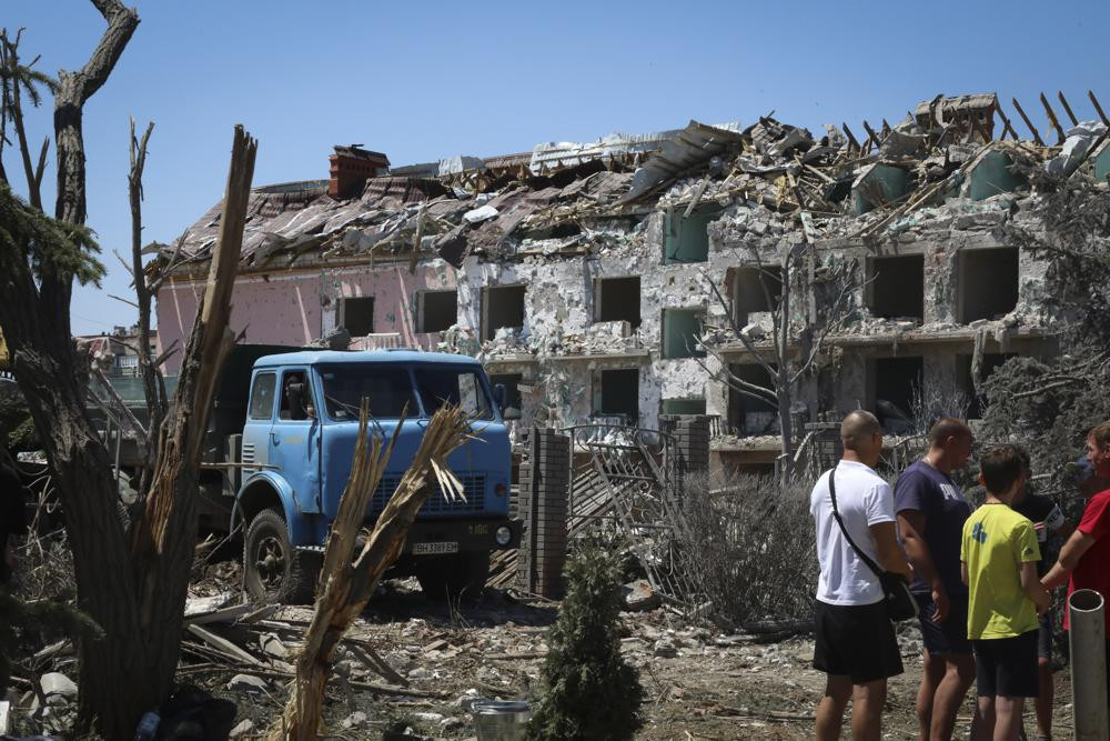 Local residents stand next to damaged residential building in the town of Serhiivka, located about 50 kilometers (31 miles) southwest of Odesa, Ukraine, Friday, July 1, 2022.  AP/RSS Photo