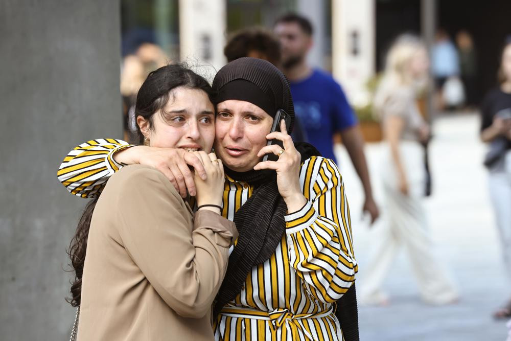 People evacuated from the Fields shopping center react, in Orestad, Copenhagen, Denmark, Sunday, July 3, 2022, after reports of shots fired. AP/RSS Photo