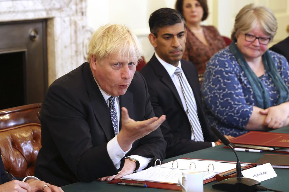 Britain's Prime Minister Boris Johnson, left, and Britain's Chancellor of the Exchequer Rishi Sunak, center, take part in a cabinet meeting, in Downing Street, London, Tuesday, July 5, 2022. (AP/RSS)