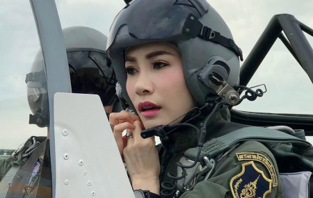 This undated photo posted Monday, Aug. 26, 2019, on the Thailand Royal Office website shows Major General Sineenatra Wongvajirabhakdi, the royal noble consort of King Maha Vajiralongkorn, in an aircraft cockpit.