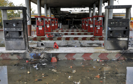 In this Nov. 20, 2019, file photo, rainwater pools at a gas station attacked during protests over government-set gasoline prices in Tehran, Iran.