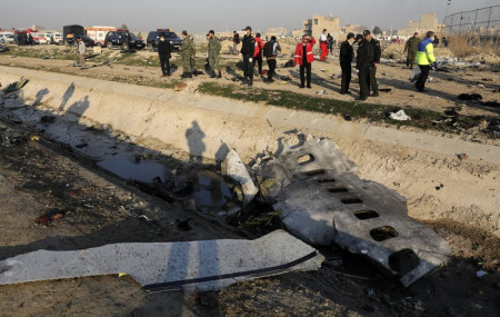 In this Jan. 8, 2020, photo, debris is seen from an Ukrainian plane which crashed as authorities work at the scene in Shahedshahr, southwest of the capital Tehran, Iran.