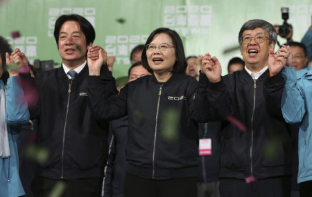 Taiwan's 2020 presidential election candidate, Taiwanese President Tsai Ing-wen, center, anf her running mate William Lai, left, celebrate their victory with supporters in Taipei, Taiwan, Saturday, Jan. 11, 2020.