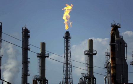 In this Thursday, Aug. 31, 2017, file photo, a flame burns at the Shell Deer Park oil refinery in Deer Park, Texas.