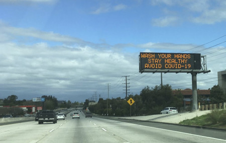 A Caltrans freeway sign reads: