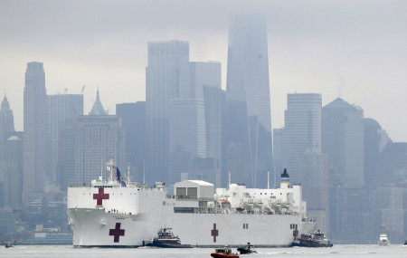 The Navy hospital ship USNS Comfort passes lower Manhattan on its way to docking in New York, Monday, March 30, 2020. The ship has 1,000 beds and 12 operating rooms.