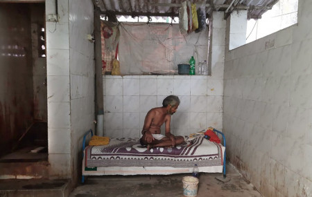 Raja Kadam rests on his bed inside a toilet complex in Dharavi, one of Asia's largest slums, in Mumbai, India, Saturday, May 16, 2020.