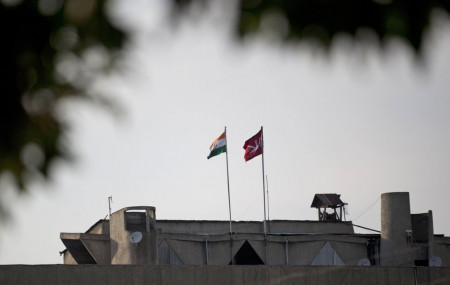 In this Aug. 9, 2019, file photo, an Indian national flag, left, is hoisted next to a Jammu and Kashmir state flag on the government secretariat building after New Delhi scrapped the disputed region’s semi-autonomy in Srinagar, Indian controlled Kashmir.