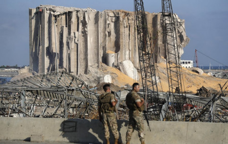 Lebanese army soldiers stand guard at the scene where an explosion hit on Tuesday the seaport of Beirut, Lebanon, Thursday, Aug. 6, 2020.