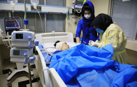 An Afghan receives treatment at hospital after suicide attack in Kabul, Afghanistan, Saturday, Oct. 24, 2020. The death toll from the suicide attack Saturday in Afghanistan's capital has risen that includes schoolchildren, the interior ministry said.