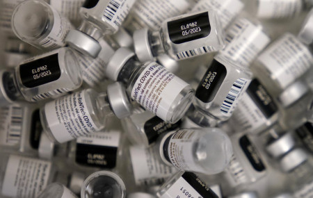 In this Friday, Jan. 22, 2021 file photo, empty vials of the Pfizer-BioNTech COVID-19 vaccine are seen at a vaccination center at the University of Nevada, Las Vegas in Las Vegas.
