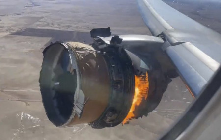 In this image taken from video, the engine of United Airlines Flight 328 is on fire after after experiencing