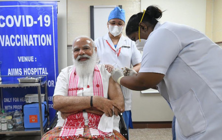 In this photo provided by Prime Minister of India Narendra Modi's twitter handle, Indian Prime Minister Narendra Modi is administered a COVID-19 vaccine in New Delhi, India, Monday, March 1, 2021.