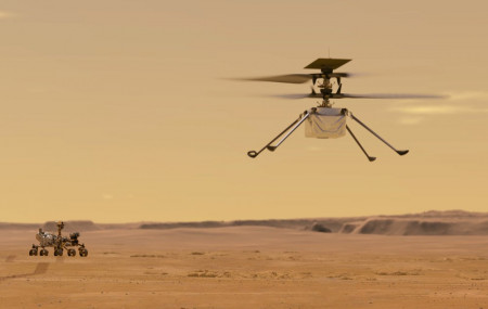 This illustration made available by NASA depicts the Ingenuity helicopter on Mars which was attached to the bottom of the Perseverance rover, background left. It will be the first aircraft to attempt controlled flight on another planet.