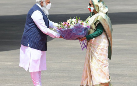 n this photo provided by Prime Minister of India Narendra Modi's twitter handle, Indian Prime Minister Narendra Modi receives a bouquet of flowers from Bangladesh's Prime Minister Sheikh Hasina in Dhaka, Bangladesh, Friday, March 26, 2021.