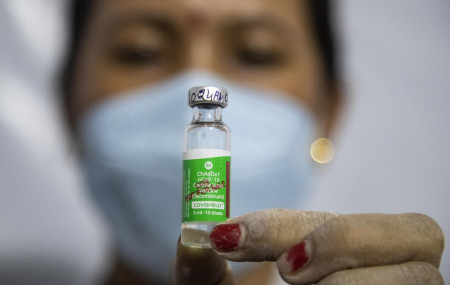 In this Monday, March 1, 2021, file photo, a health worker displays the AstraZeneca COVID-19 vaccine, manufactured by the Serum Institute of India before administering it to an elderly person in Gauhati, India.