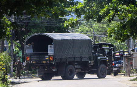 A police vehicle is parked at a road in South Okkalapa township to block anti-coup protesters' gathering in Yangon, Myanmar, Friday, April 9, 2021.