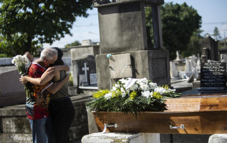 Relatives grieve during the burial service for Monica Cristina, 49, who died from complications related to COVID-19, at the Inahuma cemetery in Rio de Janeiro, Brazil, Wednesday, April 28, 2021.